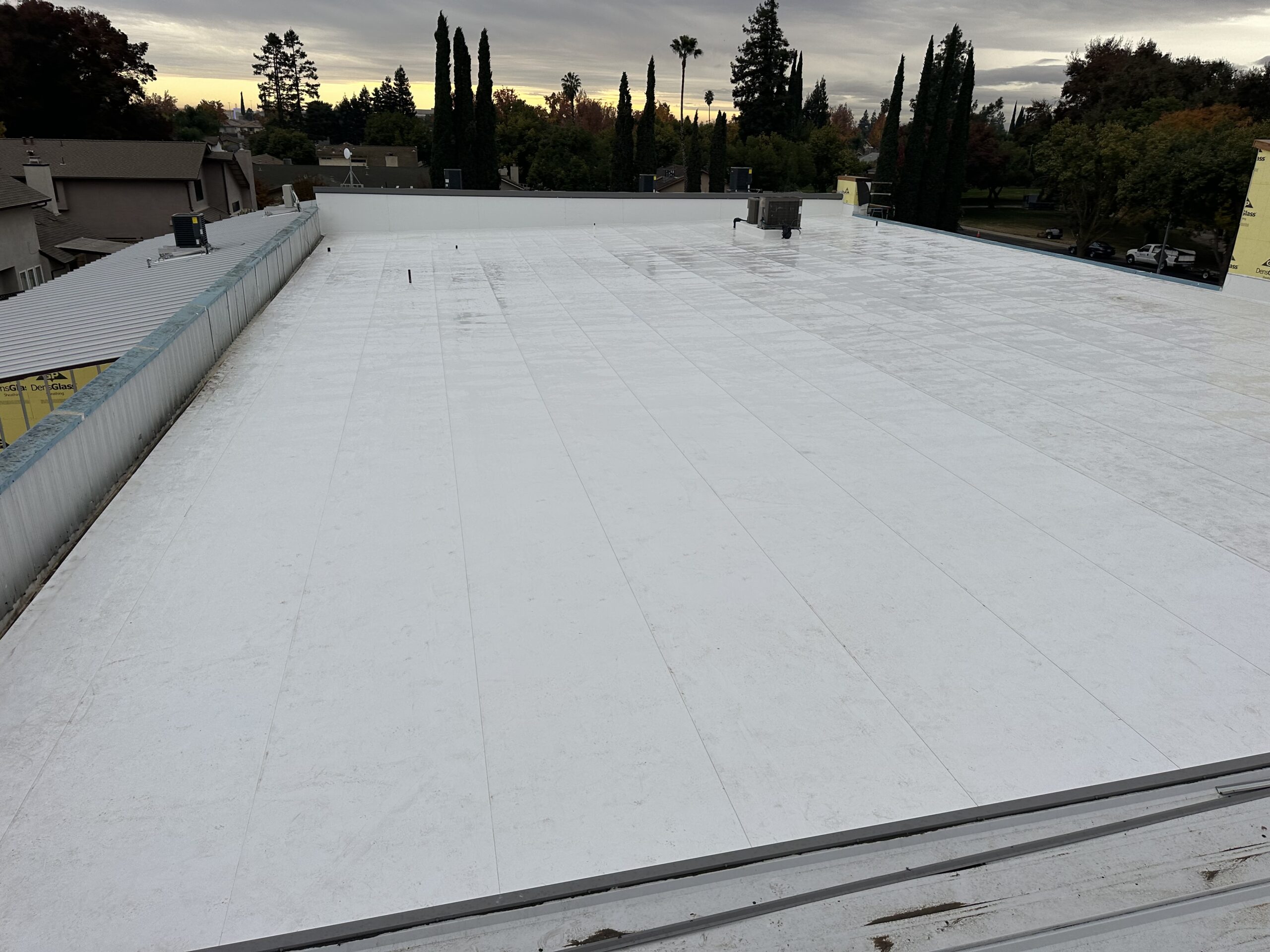 Commercial Roof Replacement, TPO Retrofit Roofing System, Modesto CA, Peterson Roofing, commercial roofing contractor, metal roof retrofit, TPO roofing membrane, flute fill insulation system, flat roof replacement, industrial roofing, roof overlay system, leak repair solution, Modesto commercial roofer