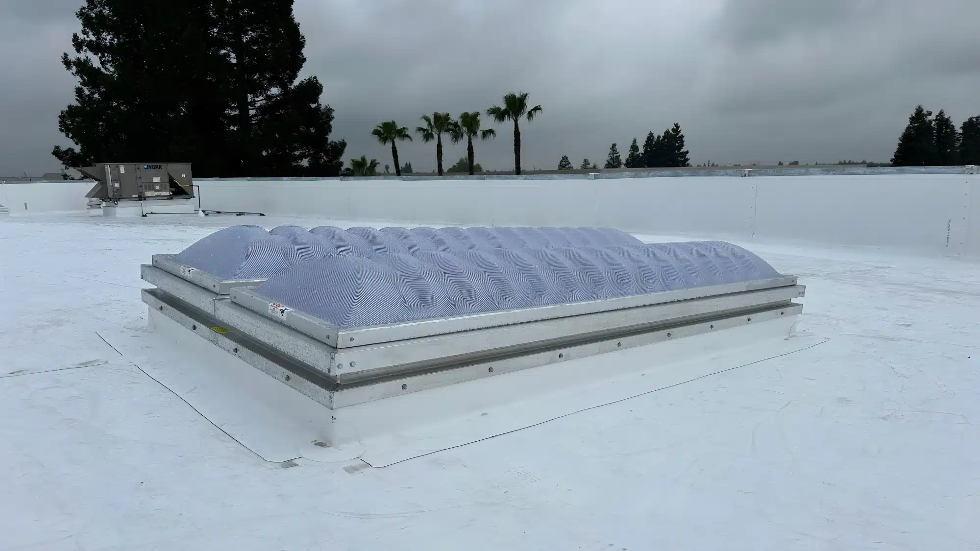 commercial flat roof being restored with elastomeric coating