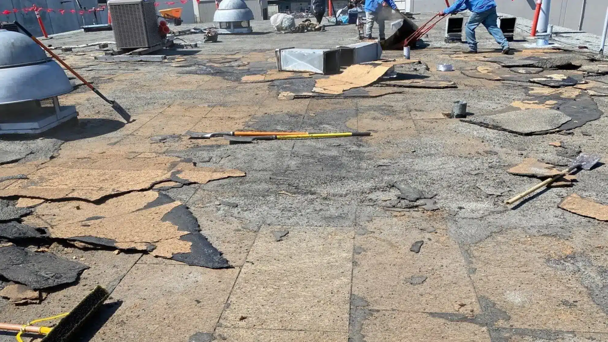 damaged commercial roof with visible cracks and wear