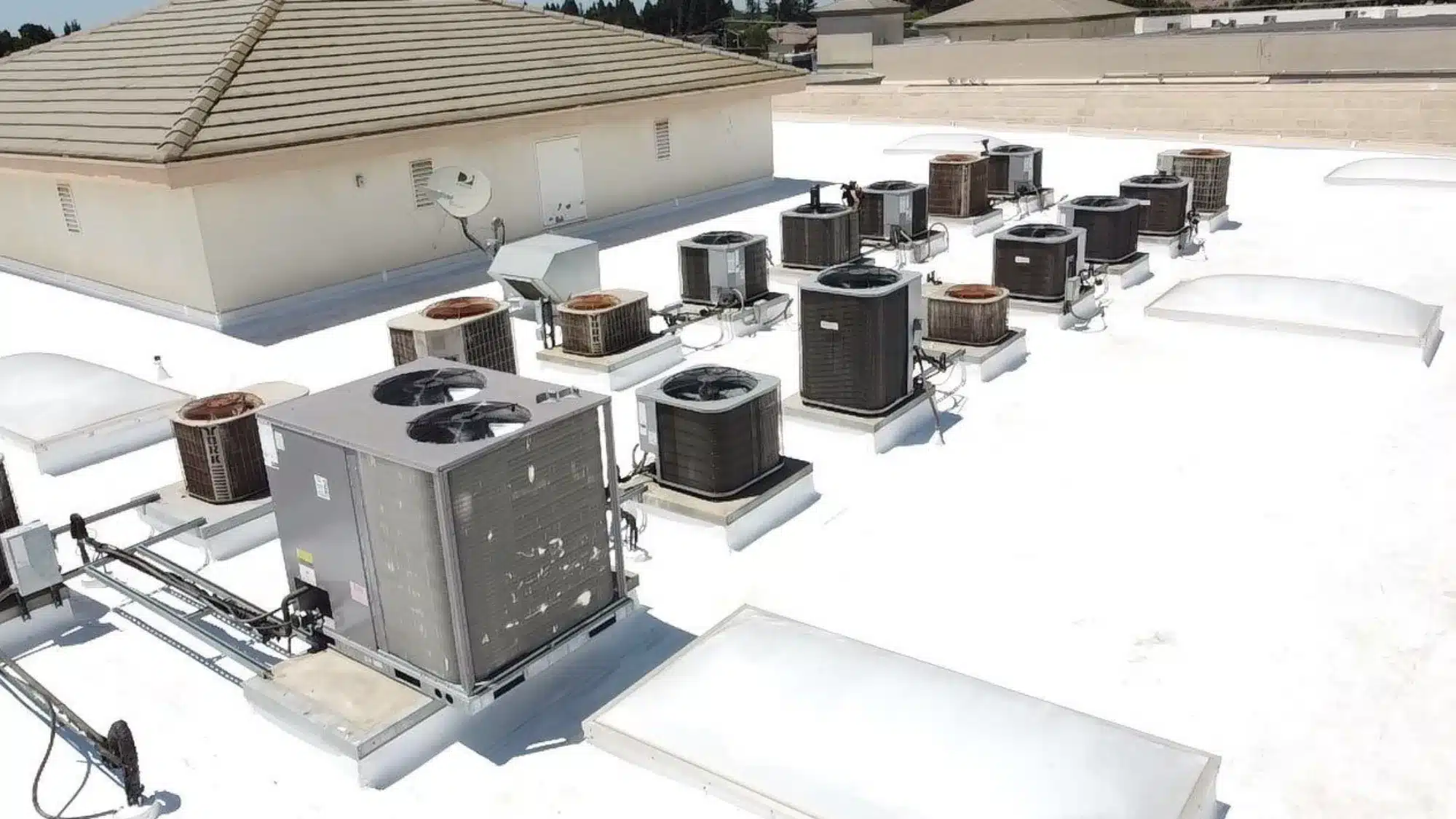 commercial roofing contractor inspecting and installing TPO roofing system on a flat commercial building for durable and weather resistant protection