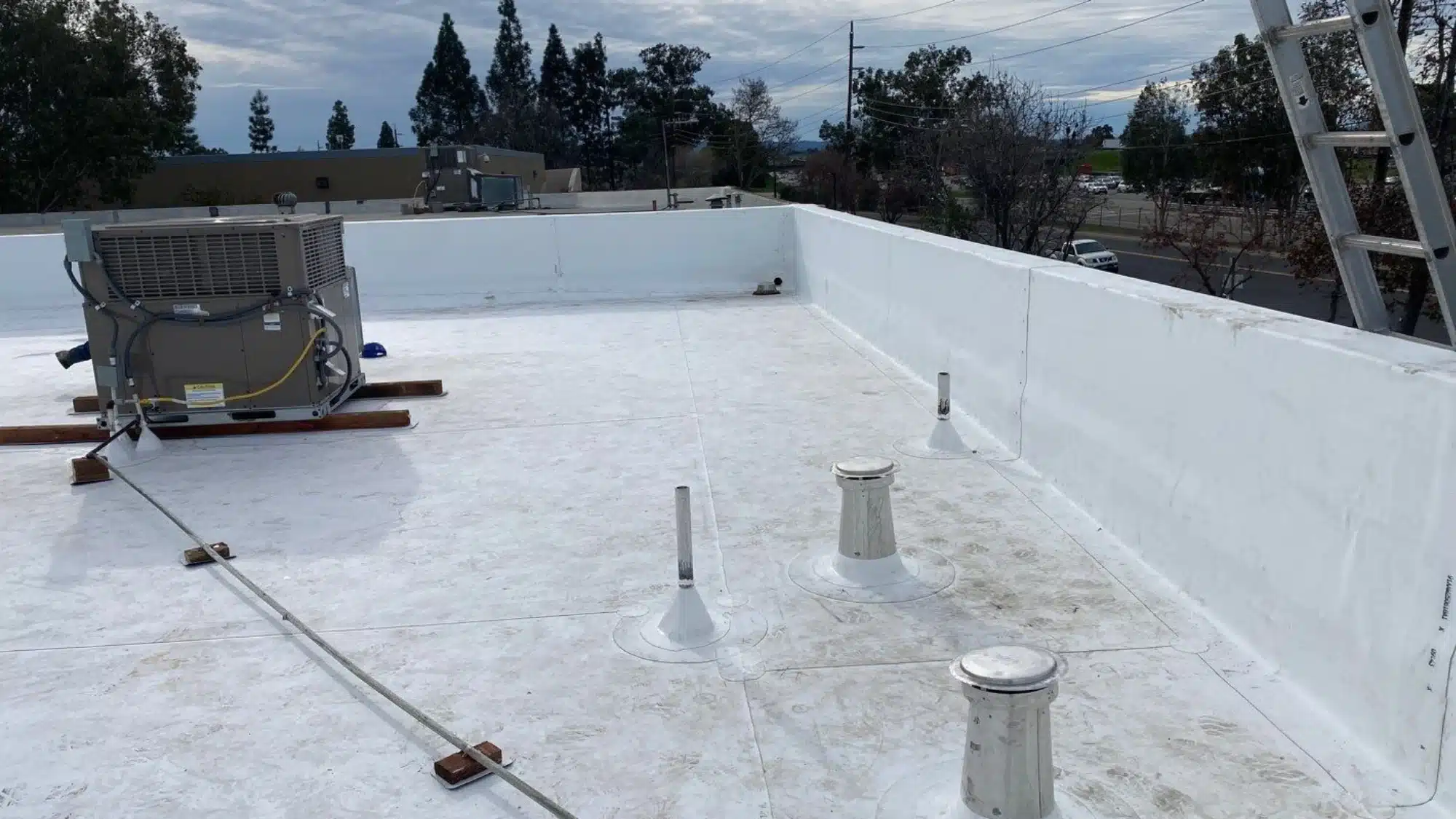 Homeowner reviewing roofing contractor estimates and checking credentials for roof repair and replacement services in Modesto California