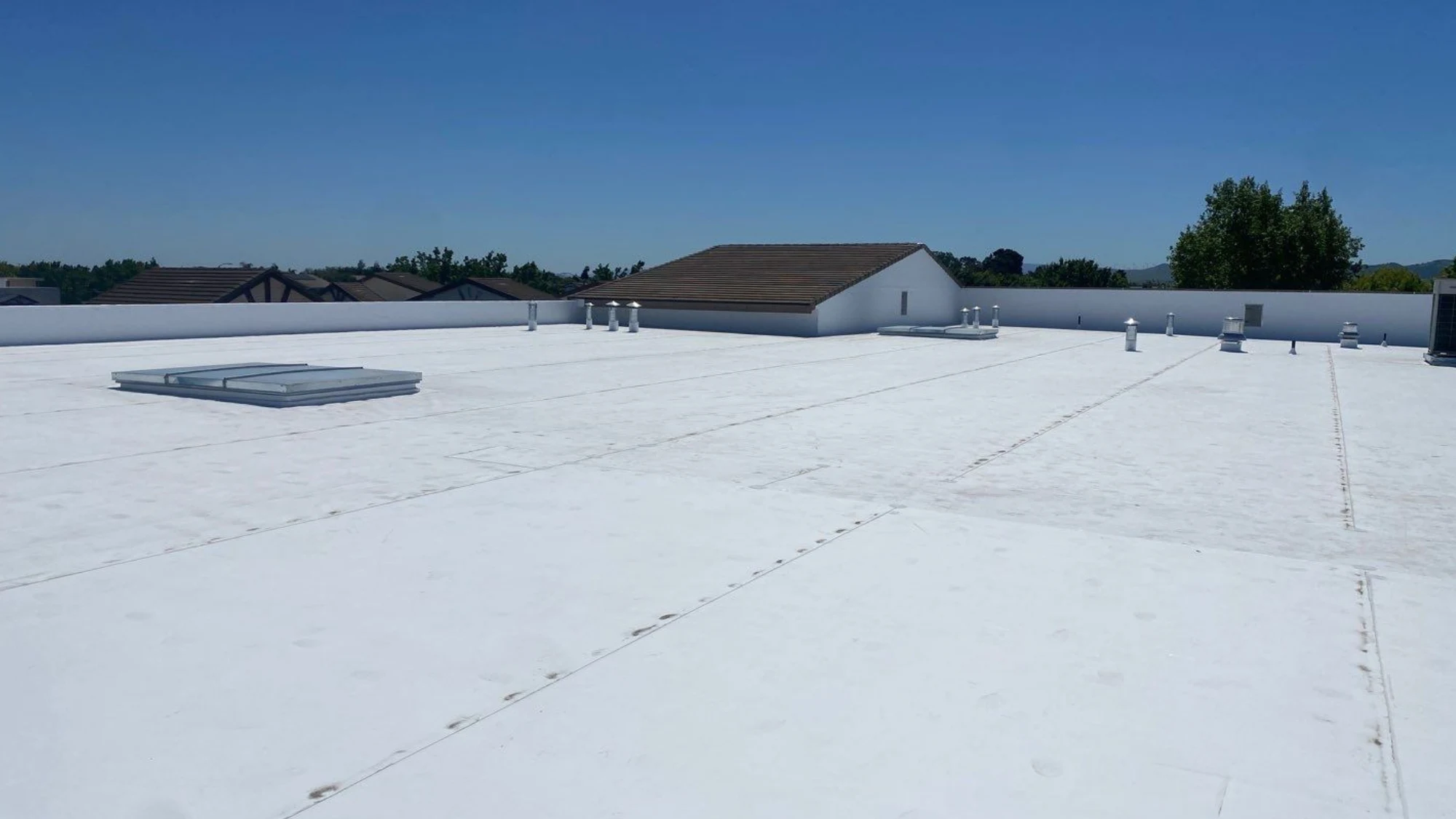 A pristine commercial roof after receiving a new protective coating in sunny California.