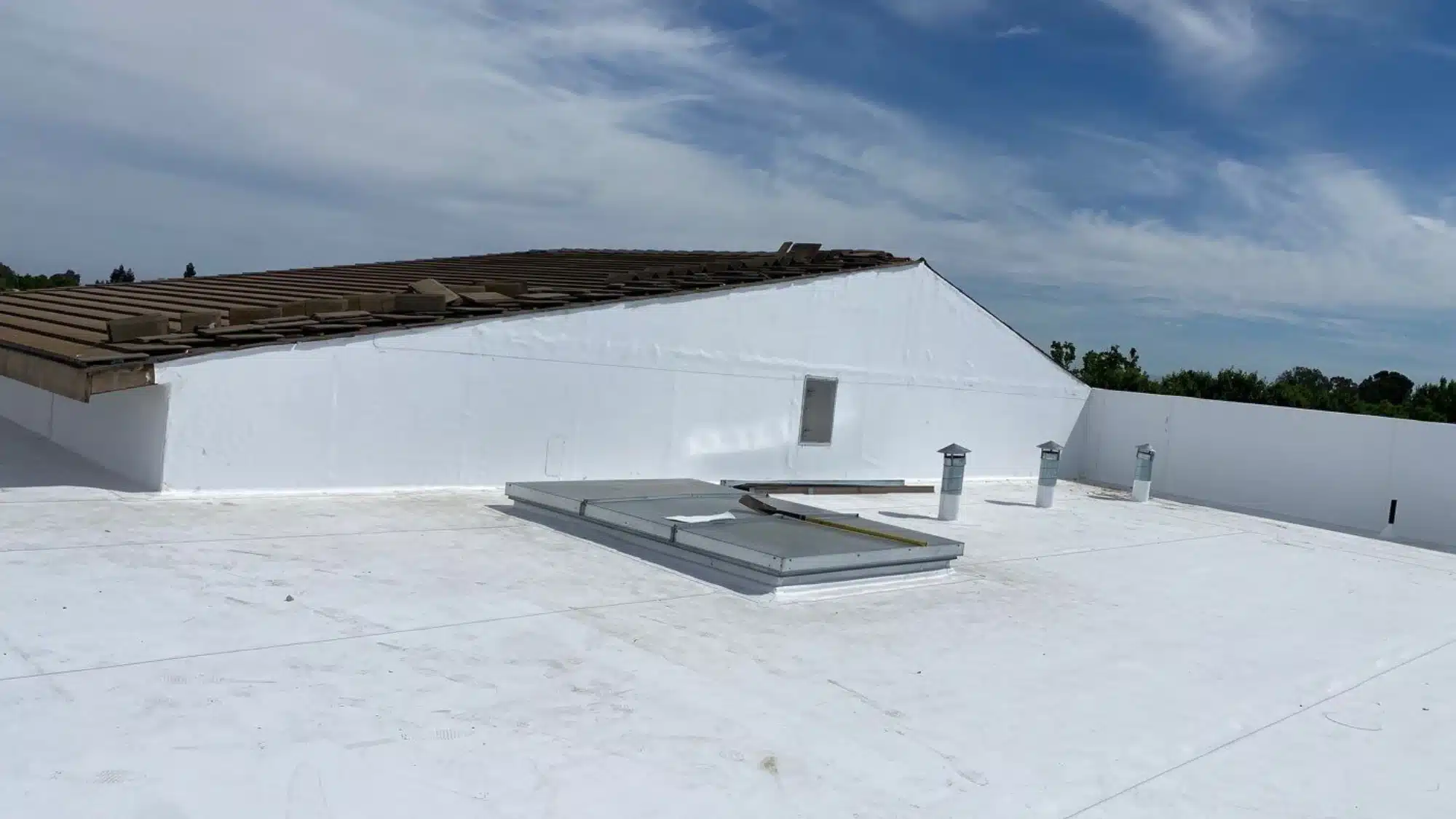 Professional roofing crew inspecting a commercial roof for service and repair needs